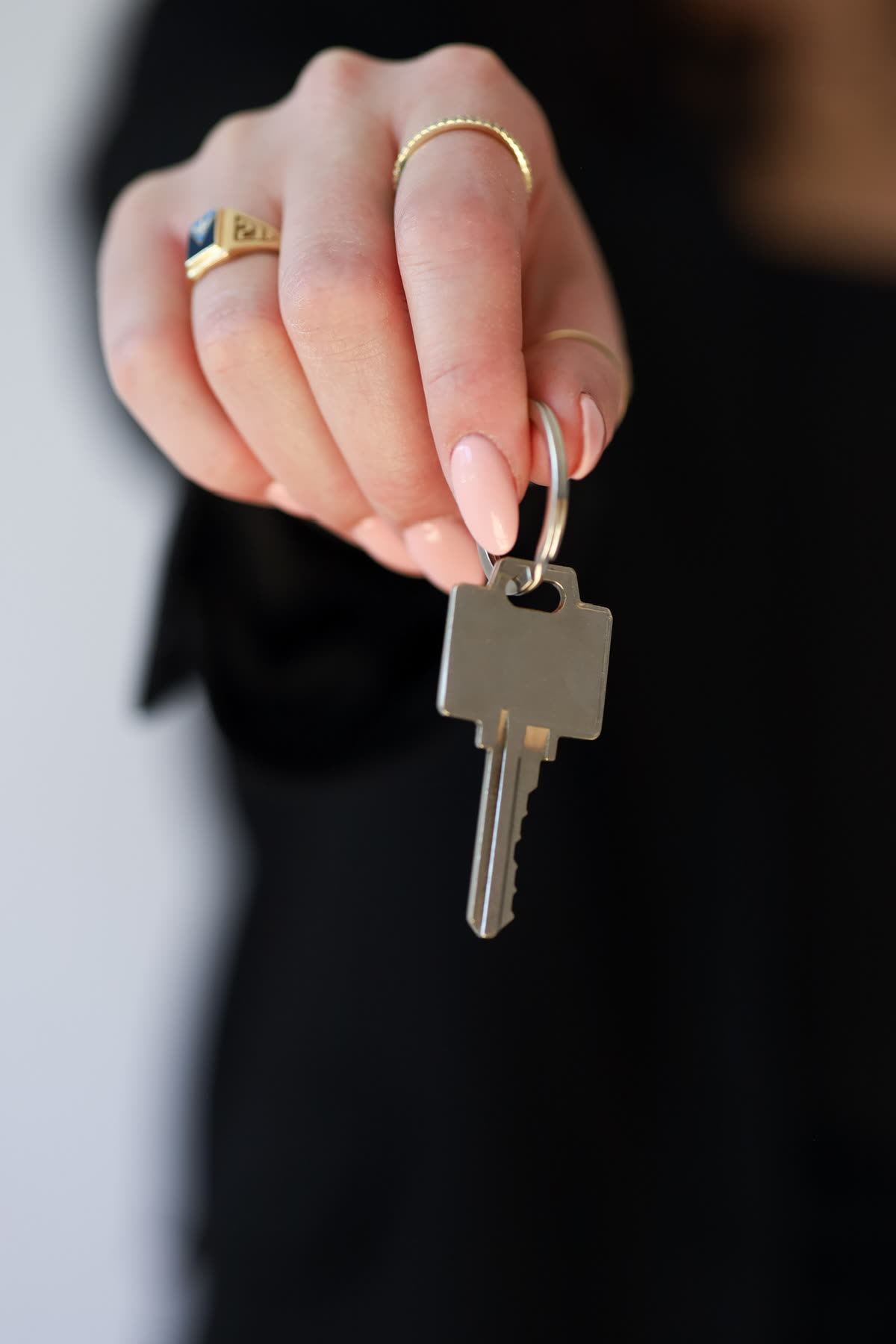 Close-up of a hand holding a single house key.